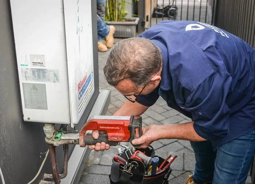 Plumber checking hot water system