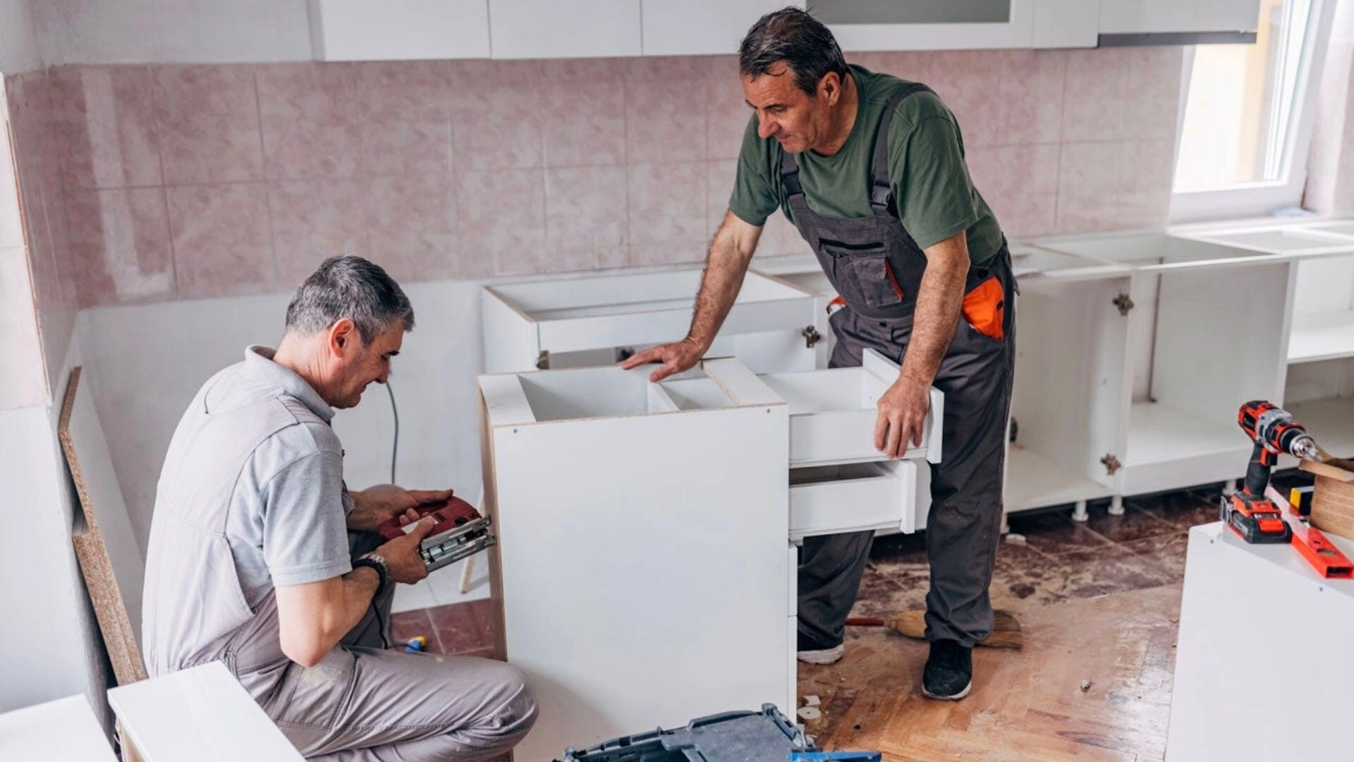 Men Fixing Cabinetry