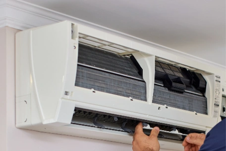 Professional air conditioning technician performing thorough aircon maintenance servicing, full clean and regas