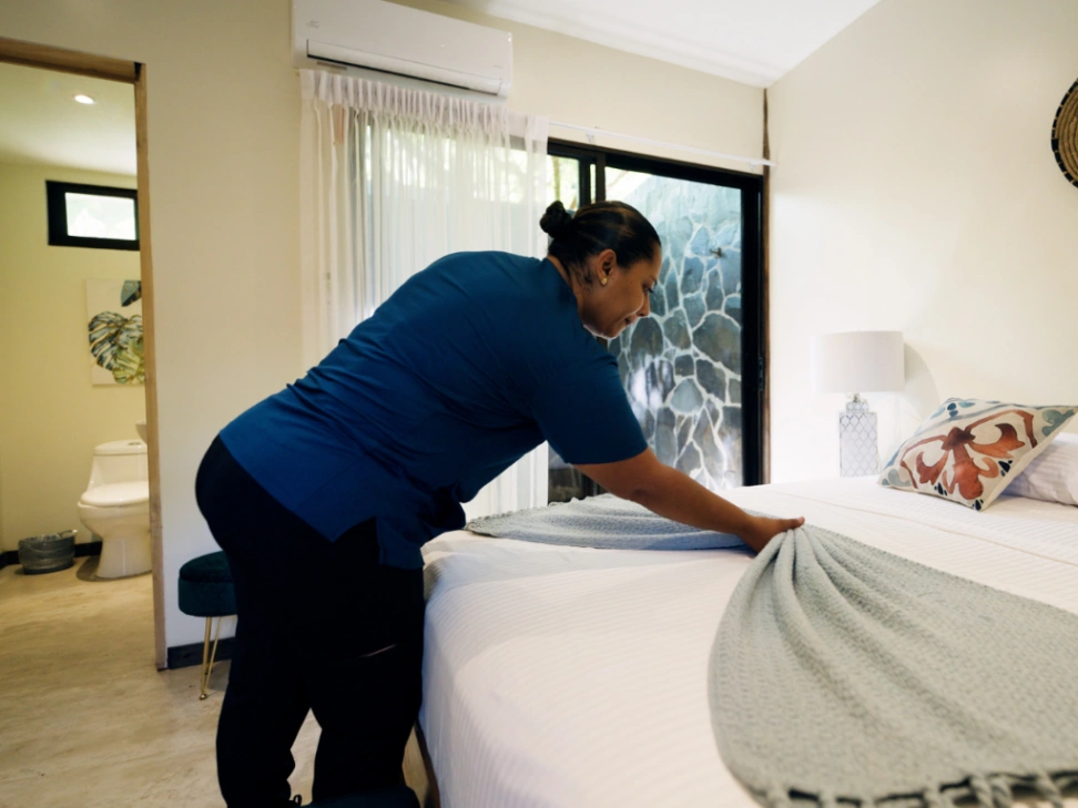 housekeeper making beds