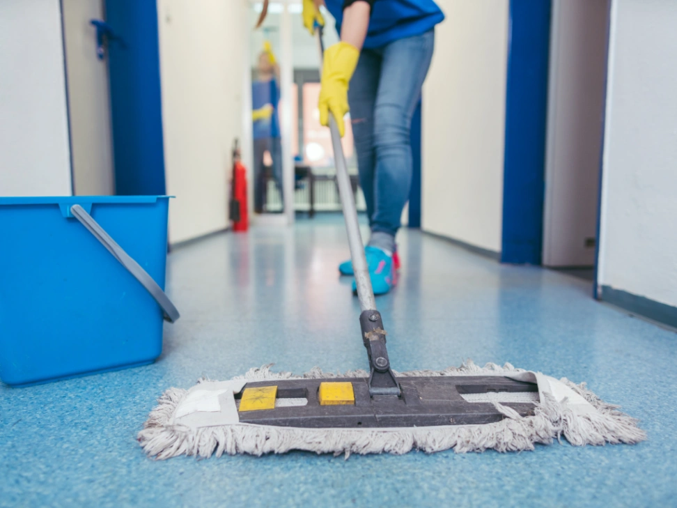 Sweeping the floor in a high traffic hallway area