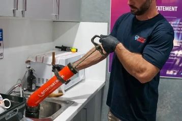 Emergency Plumber Unblocking a Kitchen Sink