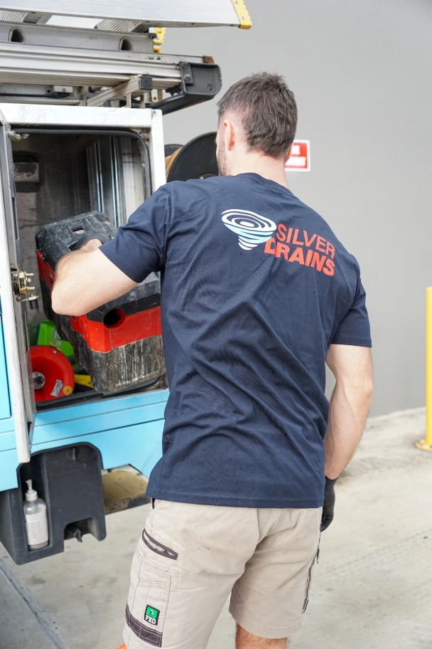 Plumber grabbing tools out of his ute