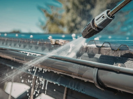 Pressure washing gutters clean