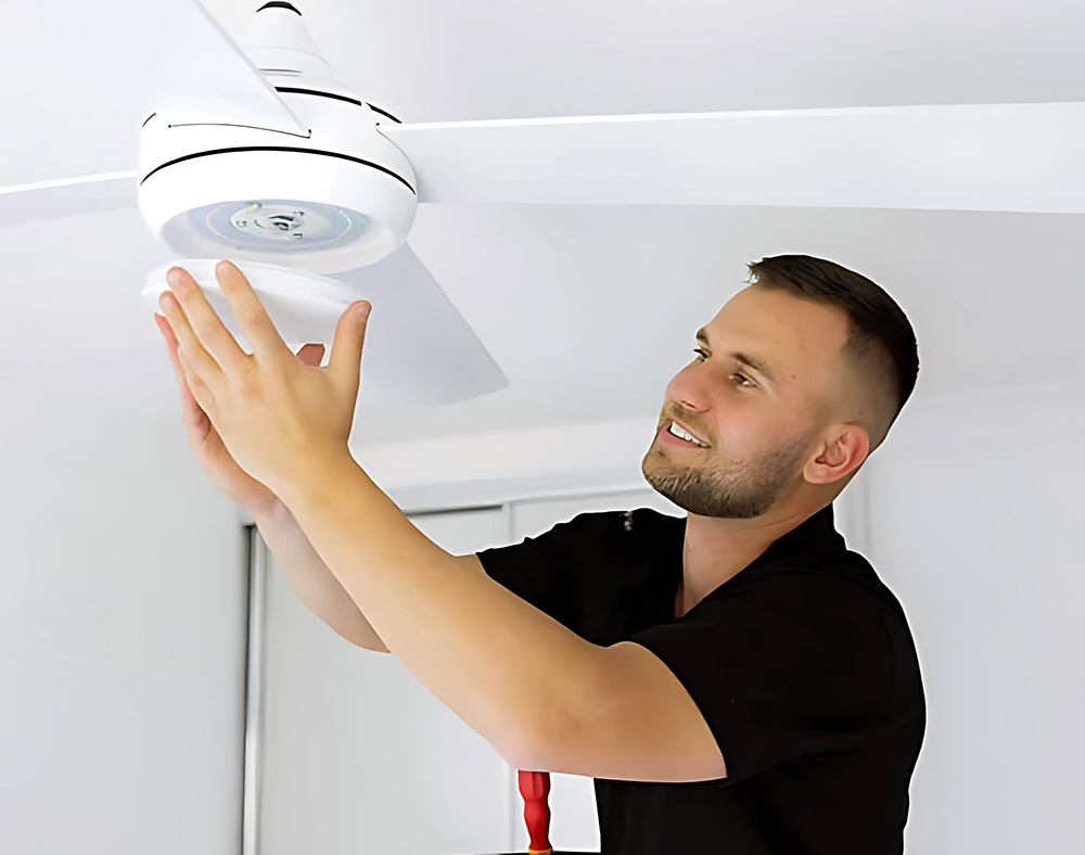 Daniel installing a ceiling fan