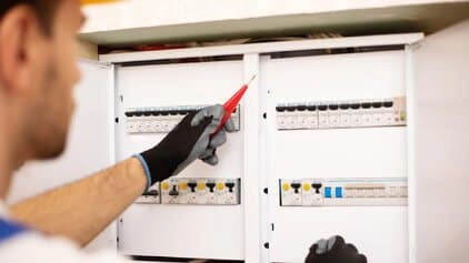 Electrician looking for a fault in his switchboard