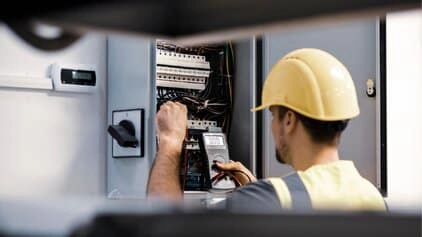 Level 2 electrician working on a switchboard