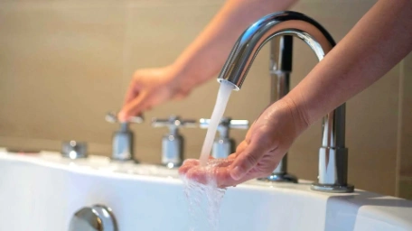 Checking the temperature of a client's hot water