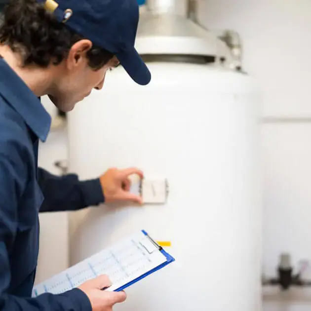 One of our plumbers checking your hot water system