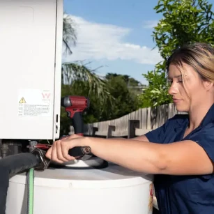 Our plumber tightening a hot water system's hose