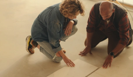Large format kitchen floor tiles being installed professionally