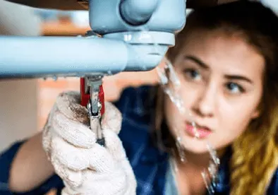 Lady trying to repair sink plumbing