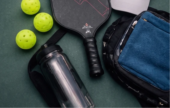 Black UPCC paddle with pickleballs