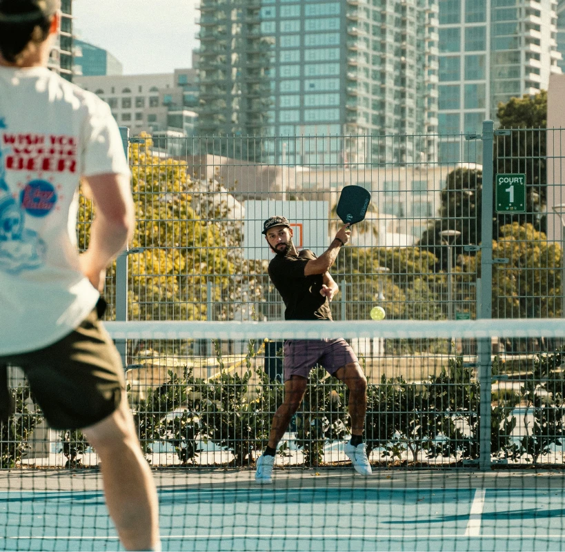 Group of pickleball players on an outdoor city court
